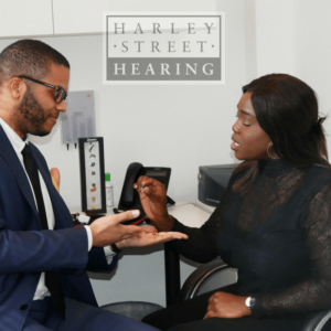 handing over hearing aids