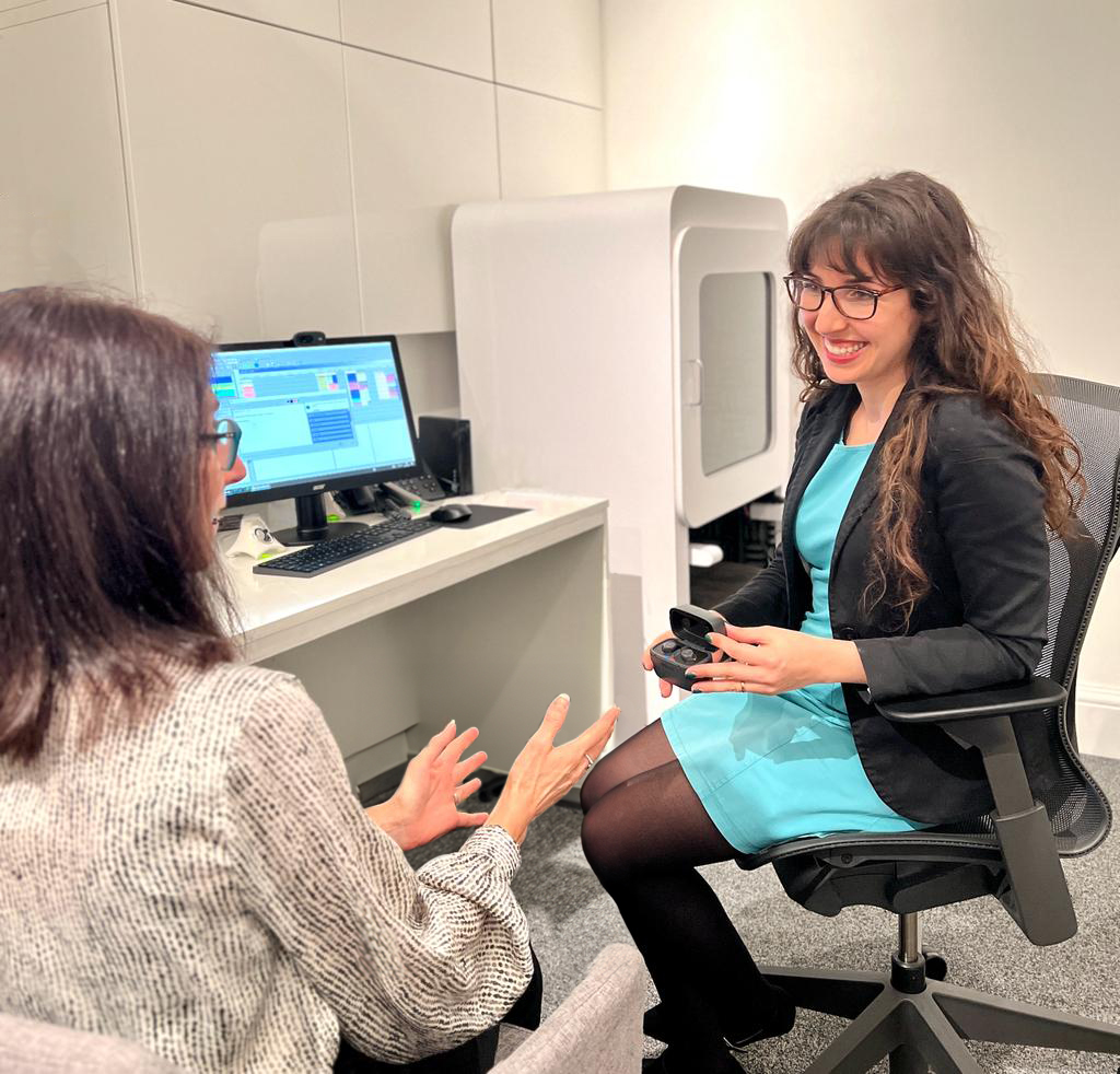 audiologist explaining hearing aid options after a hearing test
