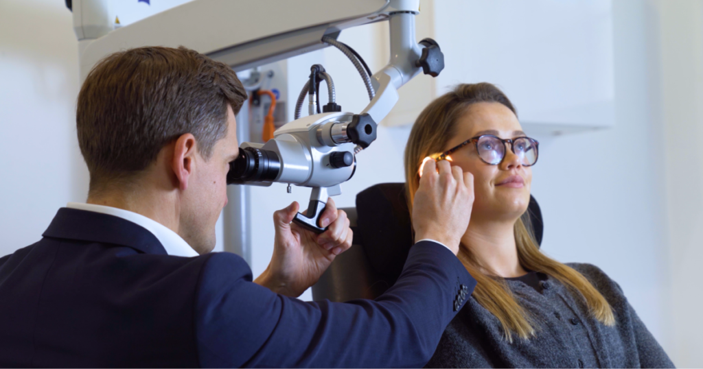 audiologist assessing ear health with microscope