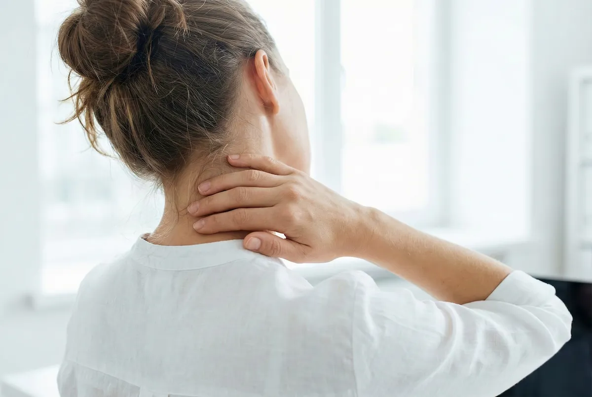Woman holding her neck in pain